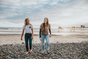 Two women in the beach wearing eco-friendly colorful nose sunscreen